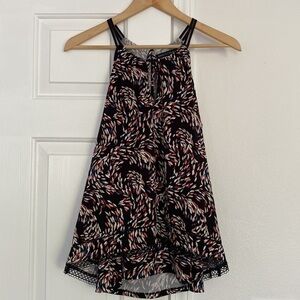 White House Black Market contemporary sleeveless blouse with open back style.